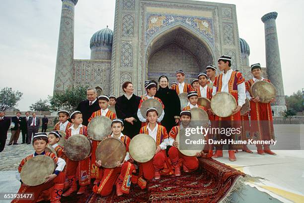 First Lady Hillary Clinton with Uzbek President Islam Karimov and his wife, Tatiana Karimova, pose with a group of young traditional Uzbek musicians,...