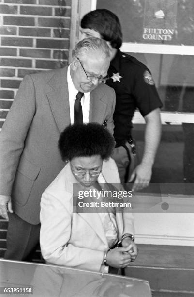 Handcuffed and closely guarded, Wayne Williams walks from Fulton County Jail to a car en route to court for a preliminary hearing June 23rd. Williams...