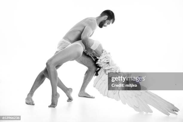 young couple posing in studio - costume wing stock pictures, royalty-free photos & images