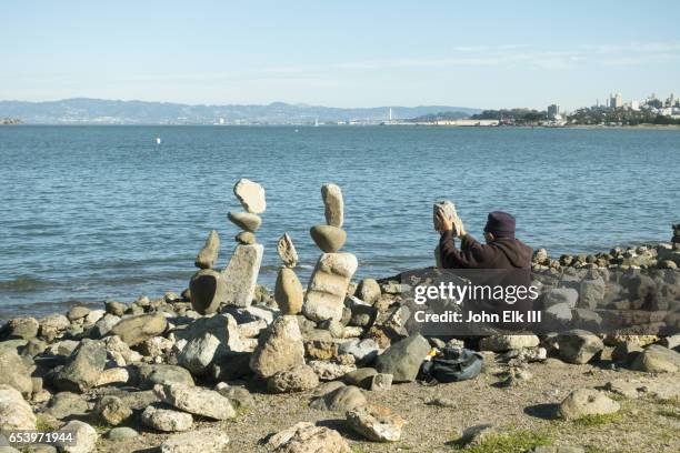 Man Stacking Rocks Photos and Premium High Res Pictures - Getty Images