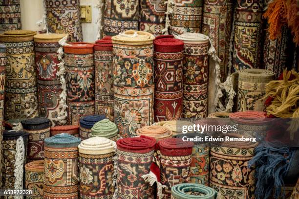 collection of rugs - carpet roll stock-fotos und bilder