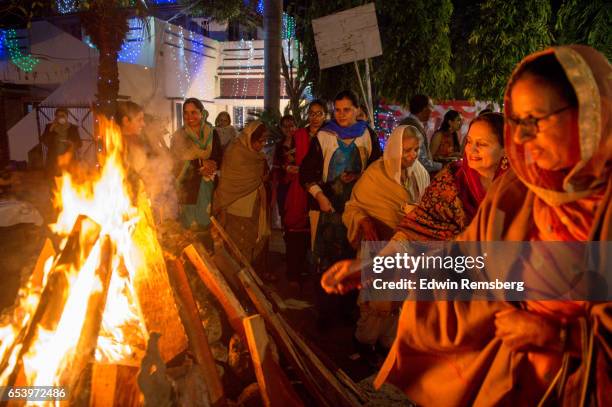 women in line with bonfire - people celebrate lohri festival stock pictures, royalty-free photos & images