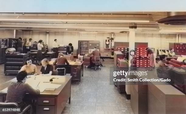 Female "human computers" perform mathmatics calculations for NASA/NACA in a typical computing area at the Langley Research Center, 1955. Image...