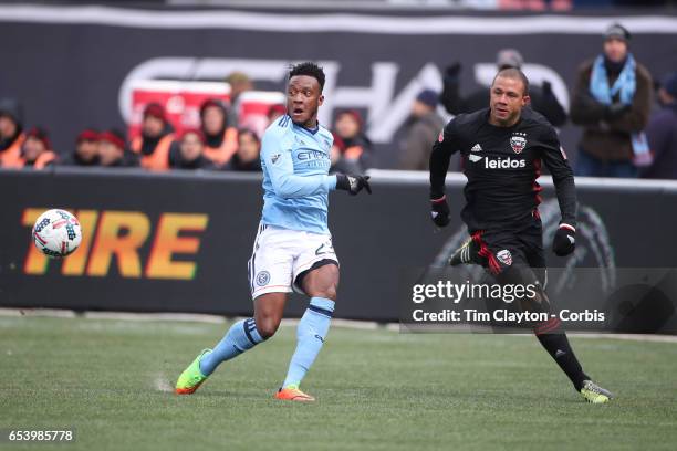 March 12: Rodney Wallace of New York City FC challenges Nick DeLeon of D.C. United during the NYCFC Vs D.C. United regular season MLS game at Yankee...