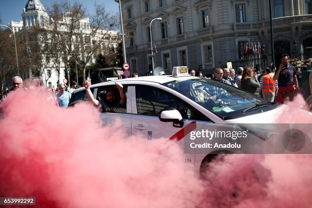 Hundred of taxi drivers who are on strike to protest take part in a protest against app-based car transport company Uber in Madrid, Spain on March...