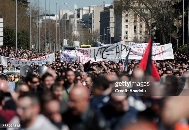 Hundred of taxi drivers who are on strike to protest take part in a protest against app-based car transport company Uber in Madrid, Spain on March...