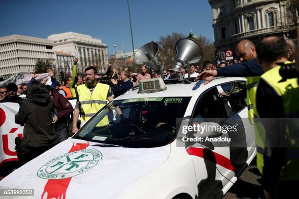 Hundred of taxi drivers who are on strike to protest take part in a protest against app-based car transport company Uber in Madrid, Spain on March...