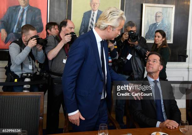 Dutch Prime Minister Mark Rutte talks with Party for Freedom leader Geert Wilders at the beginning of a meeting of Dutch political party leaders at...