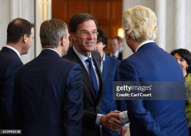 Dutch Prime Minister Mark Rutte shakes hands with Party for Freedom leader Geert Wilders during a meeting of Dutch political party leaders at the...