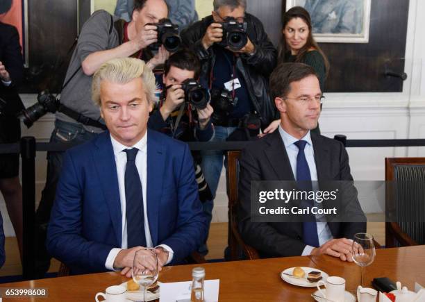Dutch Prime Minister Mark Rutte and Party for Freedom leader Geert Wilders sit next to each other during a meeting of Dutch political party leaders...