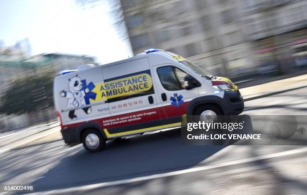 An ambulance is ridden on March 16, 2017 in Nantes, western France. / AFP PHOTO / LOIC VENANCE