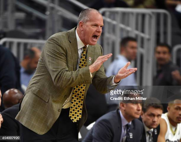 Head coach Tad Boyle of the Colorado Buffaloes gestures to his players during a first-round game of the Pac-12 Basketball Tournament against the...