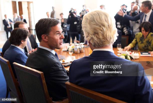 Mark Rutte, Dutch prime minister and leader of the Liberal Party , left, speaks with Geert Wilders, leader of the Dutch Freedom Party , during a...