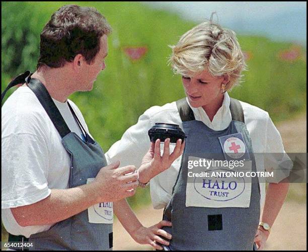 Britain's Princess Diana, wearing a heavy duty protection vest, is accompanied 15 January by a mine clearing expert of the Halo Trust during her...