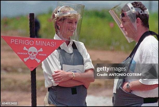 Britain's Princess Diana wearing a heavy duty protection vest and face shield, is accompanied by a mine-clearing expert of the Halo Trust 15 January...