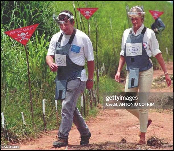 Britain's Princess Diana, wearing a heavy duty protection vest and face shield, is accompanied by a mine clearing expert during her visit to the...