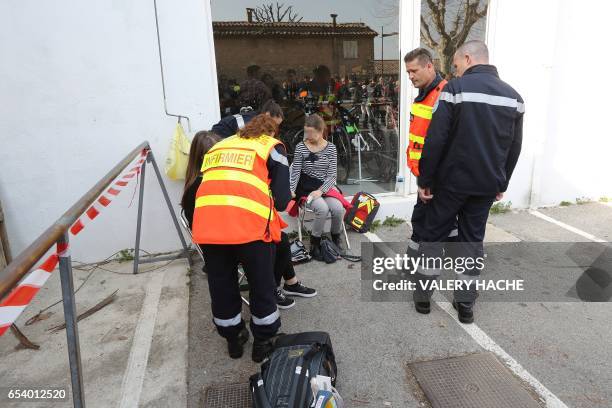 Firefighters give assistance to people near the Tocqueville high school in the southern French town of Grasse, on March 16, 2017 following a shooting...