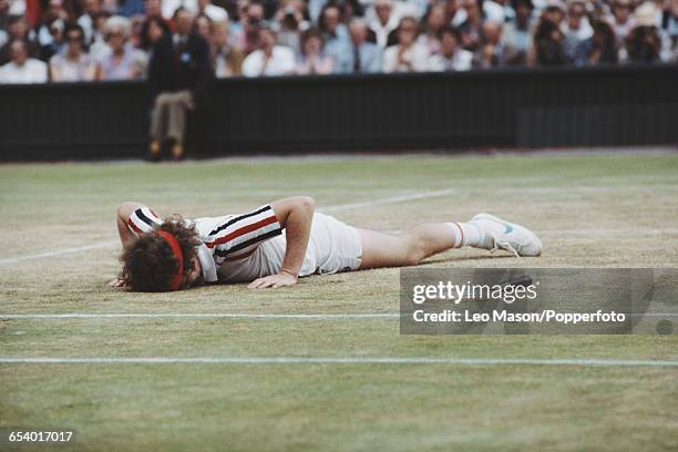 American tennis player John McEnroe pictured lying on the court durng progress to reach the final of the Men's Singles tournament before losing to...