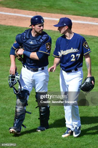 Andrew Susac and Zach Davies of the Milwaukee Brewers talk after closing out an inning against the Texas Rangers at Maryvale Baseball Park on March...