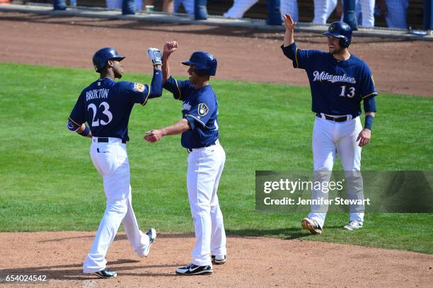 Keon Broxton of the Milwaukee Brewers is congratulated by Ivan De Jesus after hitting a three run home run in the fifth inning of the spring training...