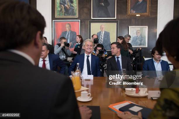 Geert Wilders, leader of the Dutch Freedom Party , center left, and Mark Rutte, Dutch prime minister and leader of the Liberal Party , speak during a...