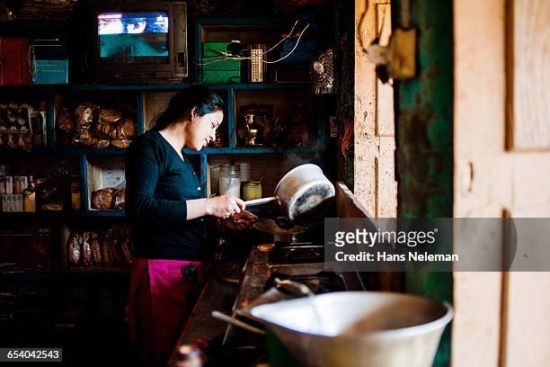 portrait of woman cooking - nepal women stock pictures, royalty-free photos & images