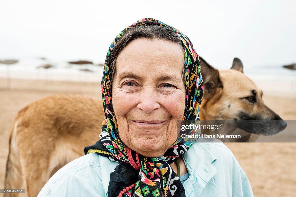 Senior woman with dog in background