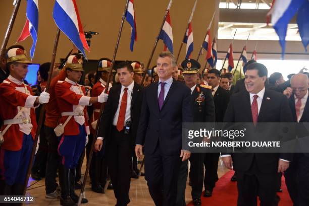 Paraguayan President Horacio Cartes and his Argentine counterpart Mauricio Macri walk during the second binational meeting of ministers and governors...
