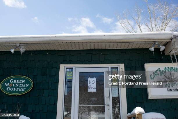 The corner store, Cat & Nine Tail, sat closed due to a widespread power outage after Tuesday's blizzard.