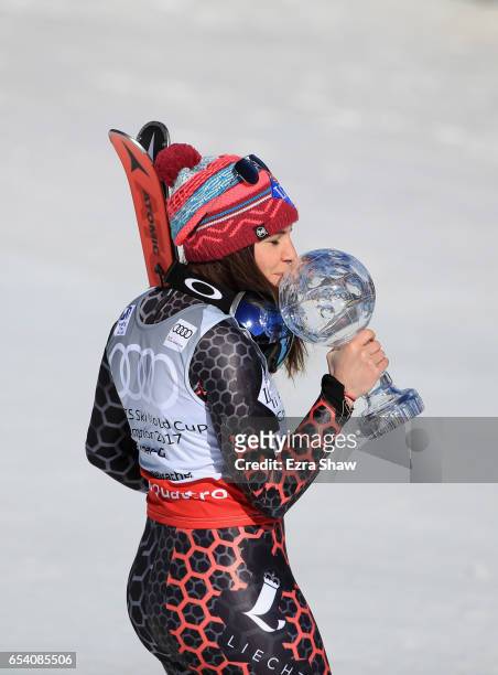 Tina Weirather of Liechtenstein kisses the globe for winning the overall title for the ladies' Super-G following the ladies' Super-G during the Audi...