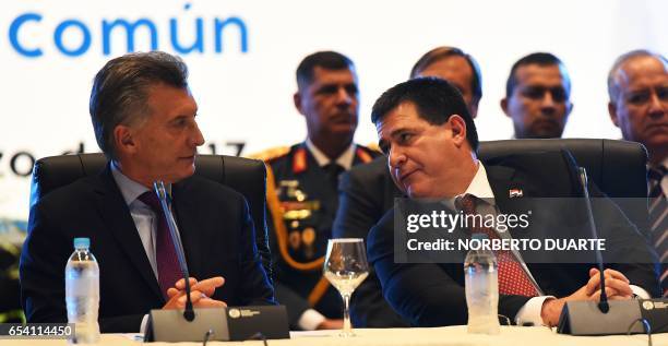 Paraguayan President Horacio Cartes and his Argentine counterpart Mauricio Macri speak during the second binational meeting of ministers and...