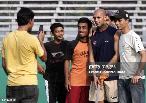 Maratha Warrior captain, Viren Rasquinha pose for photographs with young upcomig hockey players before the teams practice session at the BHA-Mahindra...