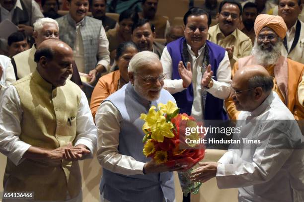 National President Amit Shah present Flower to Prime Minister Narendra Modi with Union Home Minister Rajnath Singh, and other s BJP Leader after BJP...