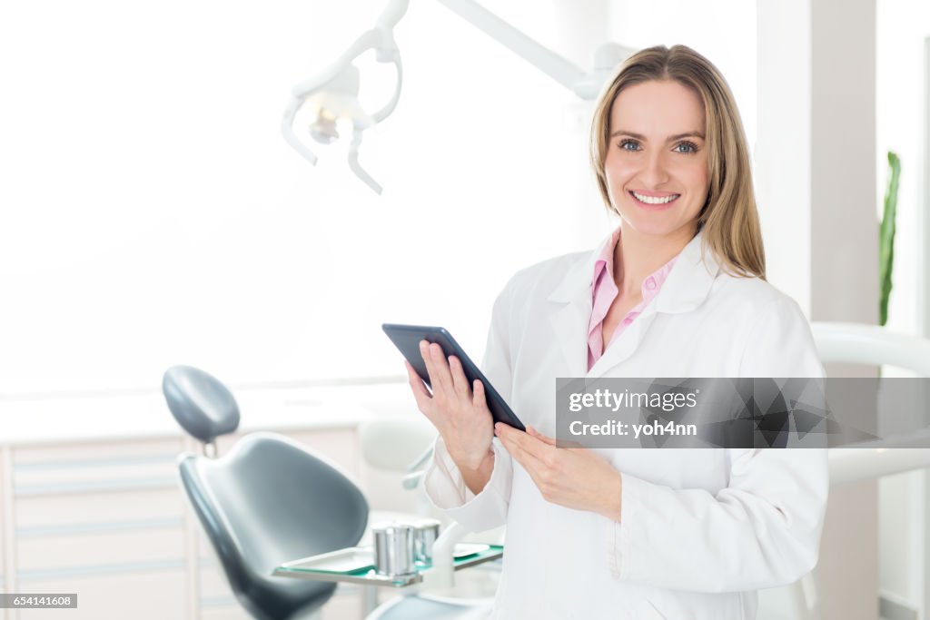 Dental hygienist with tablet