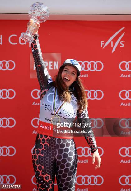 Tina Weirather of Liechtenstein celebrates with the globe after winning the overall title for the ladies' Super-G following the ladies' Super-G race...