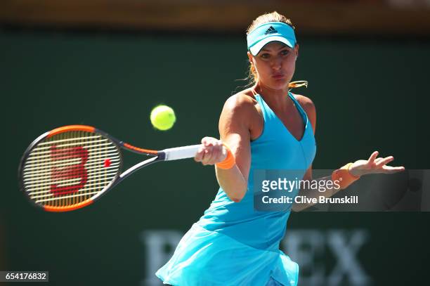 Kristina Mladenovic of France plays a forehand against Caroline Wozniacki of Denmark in their quarter final match during day eleven of the BNP...