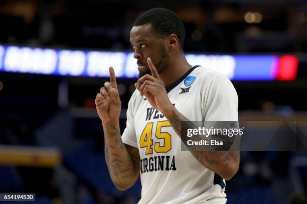 Elijah Macon of the West Virginia Mountaineers celebrates after defeating the Bucknell Bison with a score of 86 to 80 during the first round of the...