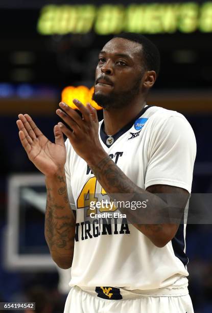 Elijah Macon of the West Virginia Mountaineers celebrates after defeating the Bucknell Bison with a score of 86 to 80 during the first round of the...