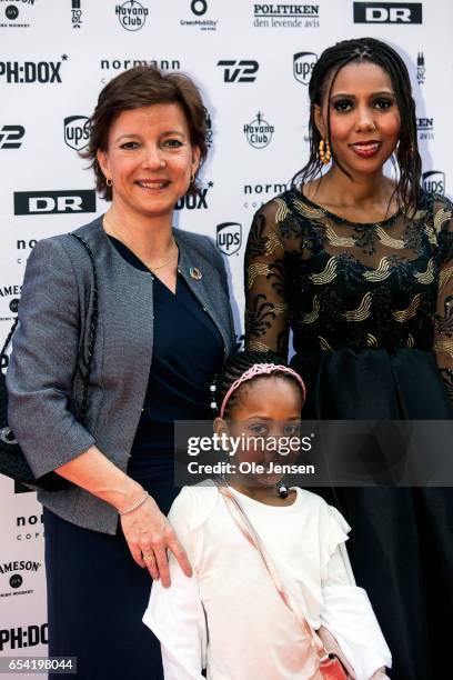 Jaha Dukureh together with Danish Minister for equality, Karen Ellemann, and Dukureh's daughter pose on the red carpet before the world premiere of...