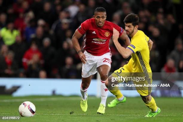 Antonio Valencia of Manchester United competes with Denis Terentjev of FK Rostov during the UEFA Europa League Round of 16 second leg match between...