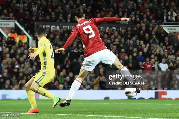 Manchester United's Swedish striker Zlatan Ibrahimovic does a backward flick to lay the ball off for Manchester United's Spanish midfielder Juan Mata...