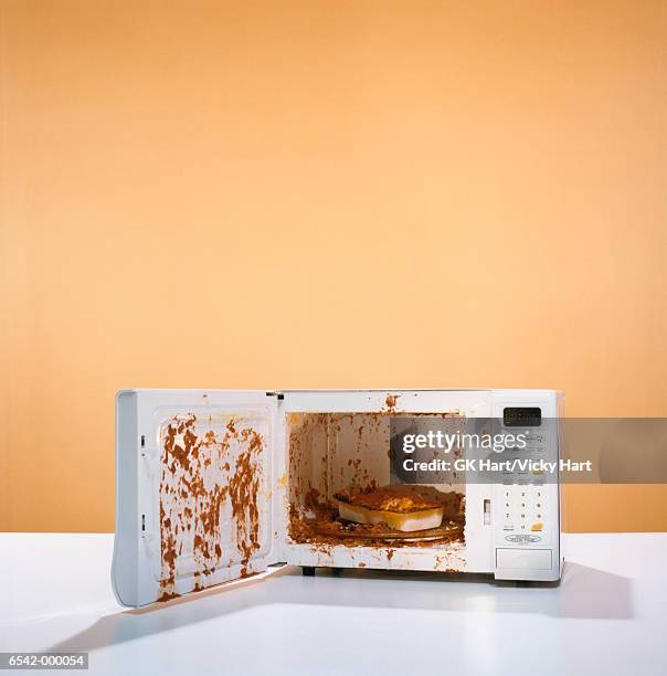 exploded meal in microwave - microwave stock pictures, royalty-free photos & images