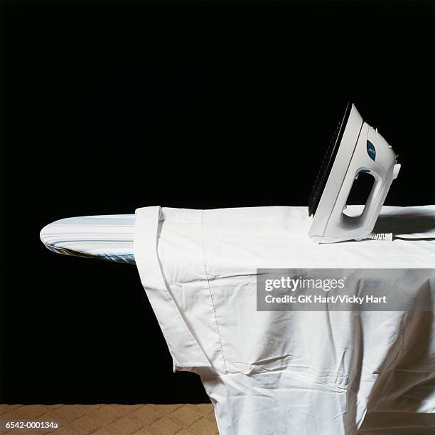 shirt on ironing board - ironing board imagens e fotografias de stock