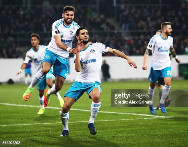 Nabil Bentaleb of Schalke 04 celebrates with Daniel Caligiuri of Schalke 04 after scoring a penalty goal during the UEFA Europa League Round of 16...