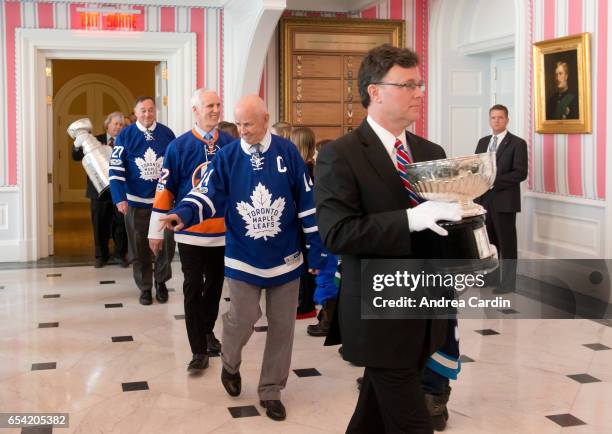 Craig Campbell of the Hockey Hall of Fame carries in the original bowl of the Stanley Cup during the Stanley Cup Homecoming as part of the Stanley...