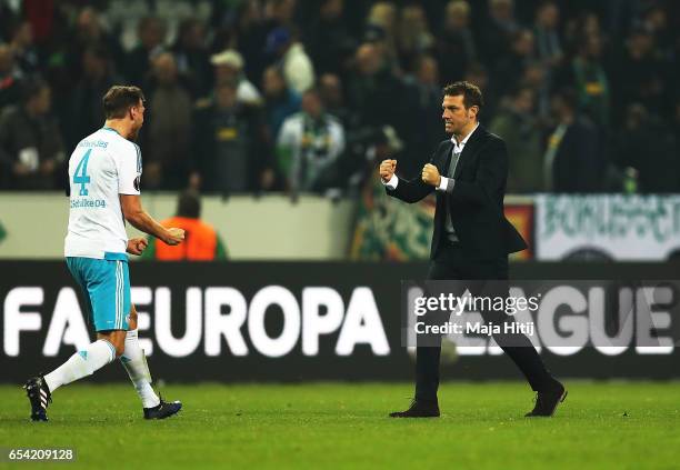 Benedikt Hoewedes of Schalke 04 celebrates with Markus Weinzierl after the UEFA Europa League Round of 16 second leg match between Borussia...