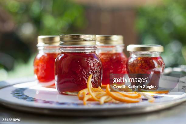 jars filled with freshly made bitter orange marmalade - preserves stockfoto's en -beelden