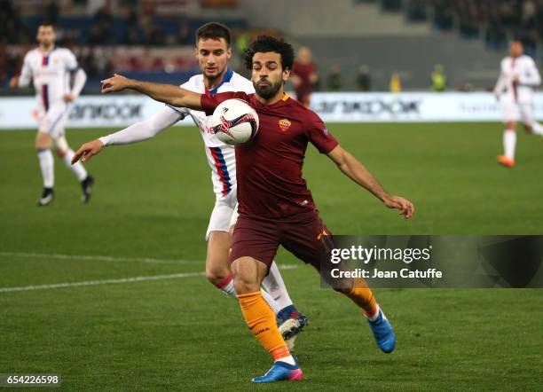 Emanuel Mammana of Lyon and Mohamed Salah of AS Roma in action during the UEFA Europa League Round of 16 second leg match between AS Roma and...