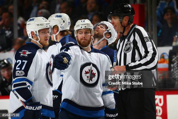 Bryan Little of the Winnipeg Jets speaks with linesman Pierre Racicot after a goal was disallowed for a player being off sides against the New York...