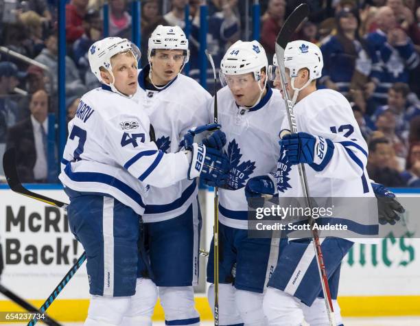 Leo Komarov, Alexey Marchenko, Morgan Rielly, and Connor Brown of the Toronto Maple Leafs celebrate a goal during the second period against the Tampa...